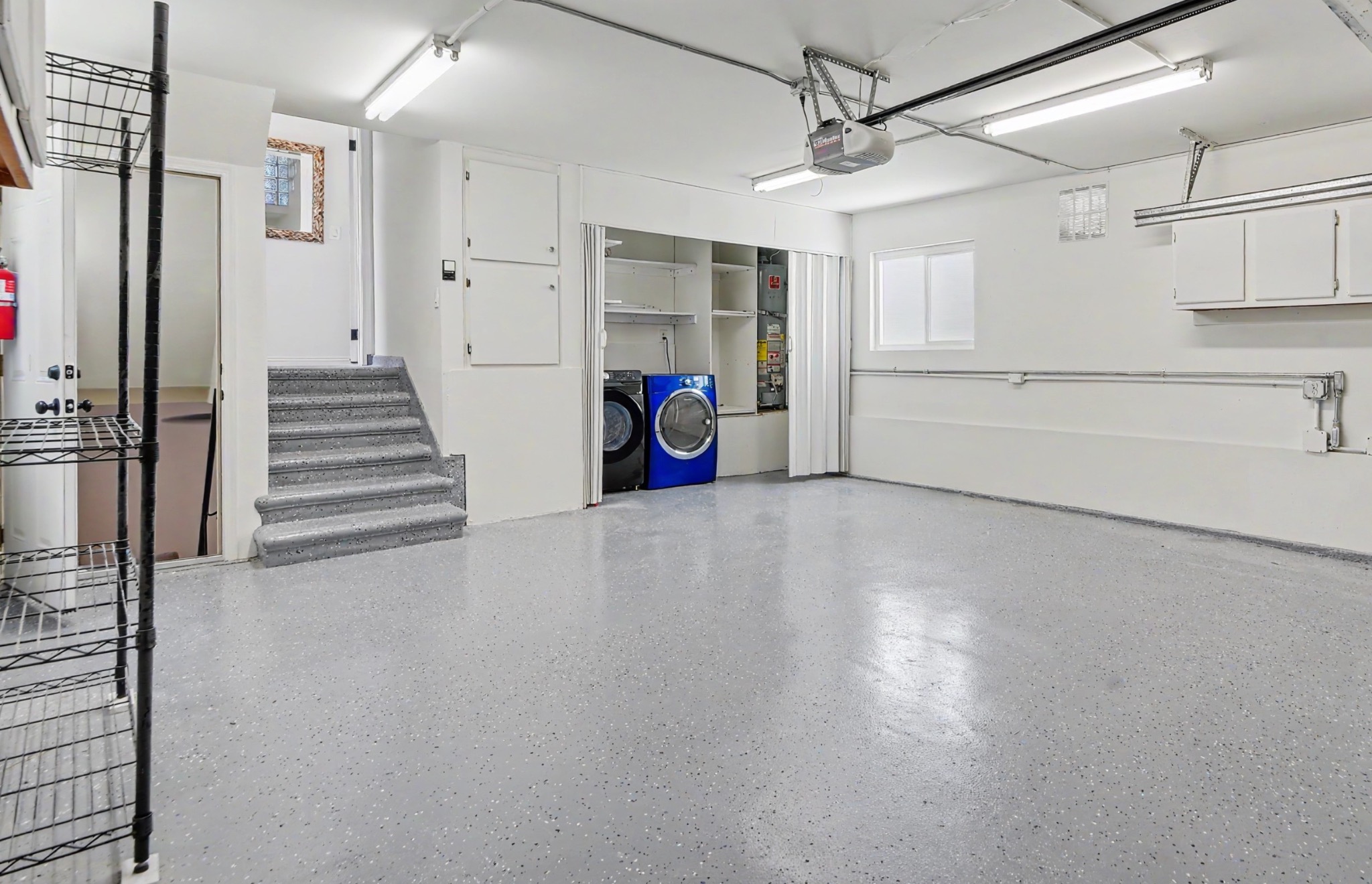 Attached two-car garage with epoxy floor and laundry area
