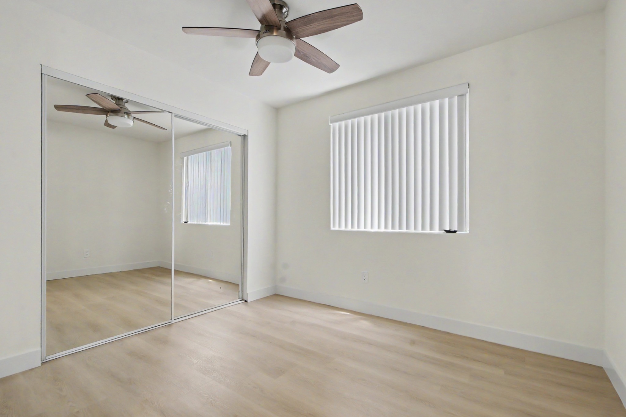 Bright lower bedroom with mirrored wardrobe doors