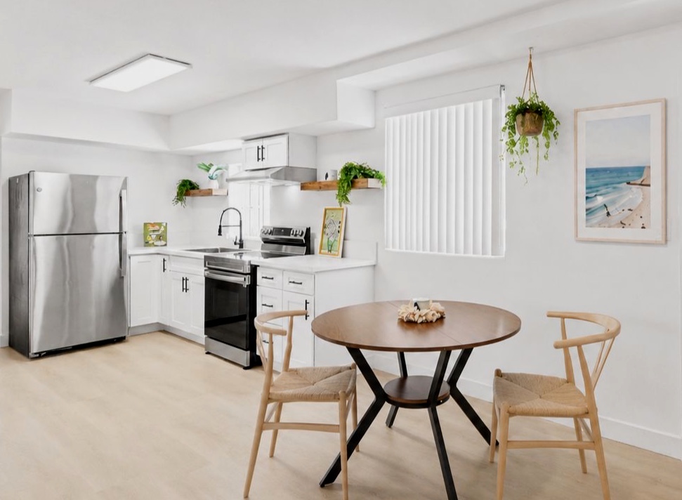 Updated lower kitchen with dining area and stainless steel appliances